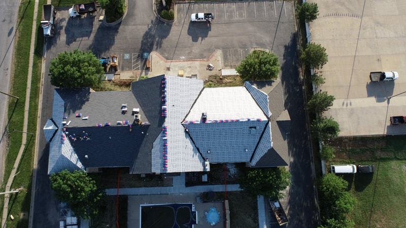 Aerial view of a completed commercial roof by American Roofing