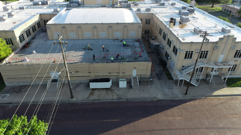 Aerial view of a completed commercial roof by American Roofing