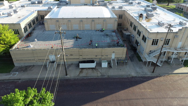 Aerial view of a completed commercial roof by American Roofing