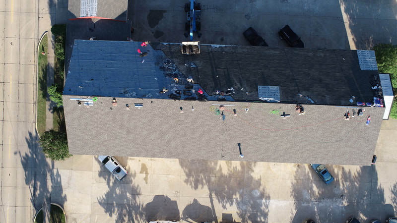 Aerial view of a completed commercial roof by American Roofing