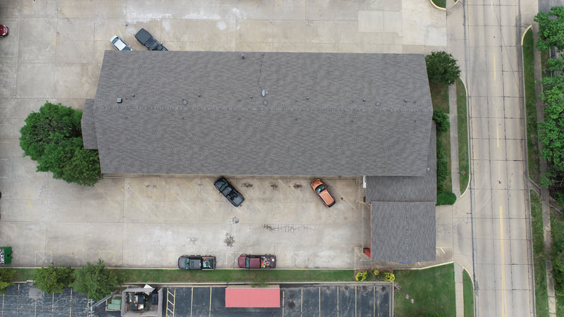 Aerial view of a completed commercial roof by American Roofing