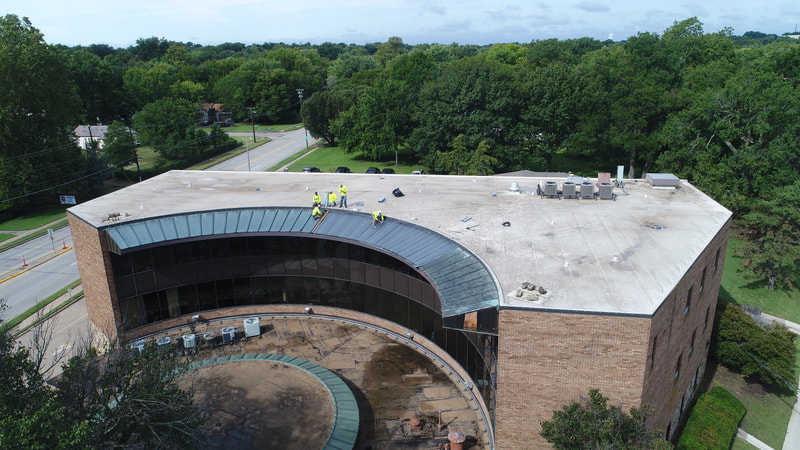 Aerial view of a completed commercial roof by American Roofing